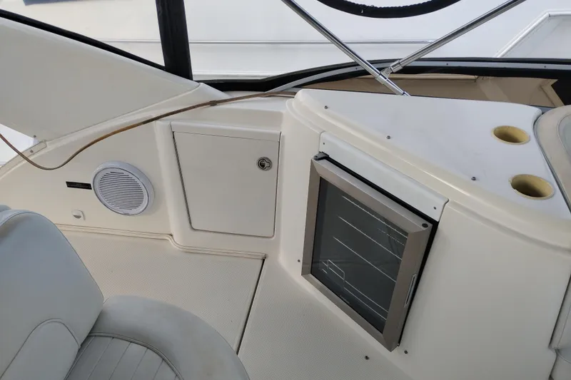 Slide: The Image of 2004 Meridian 459 Motoryacht interior with seating, speaker, and storage compartment. - 22
