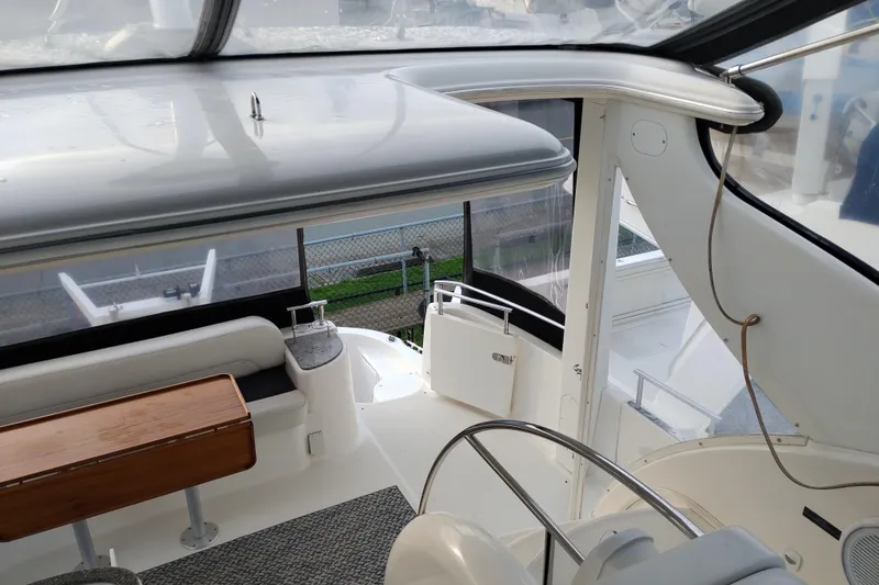 Slide: The Image of 2004 Meridian 459 Motoryacht interior with seating and wooden table, showcasing luxury design. - 23
