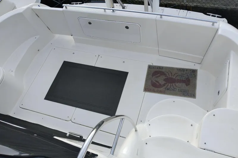 Slide: The Image of 2004 Meridian 459 Motoryacht deck with lobster-themed mat and seating area. - 24