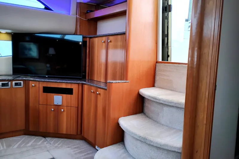 Slide: The Image of Interior of 2004 Meridian 459 Motoryacht with TV, wooden cabinets, and carpeted stairs. - 26