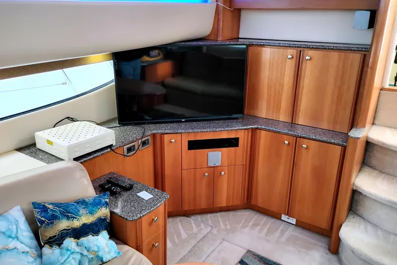 Slide: The Image of Luxurious interior of 2004 Meridian 459 Motoryacht with TV, cabinets, and plush seating. - 27