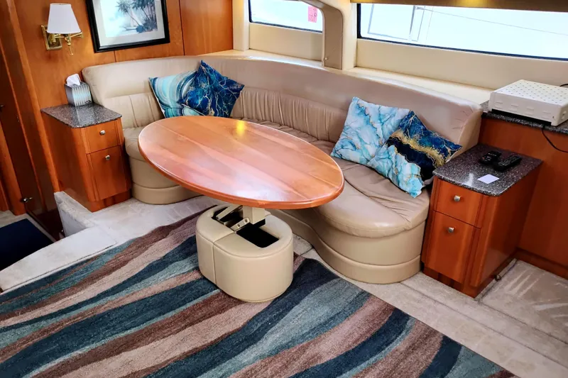 Slide: The Image of Luxurious 2004 Meridian 459 Motoryacht interior with curved seating and elegant wooden table. - 29