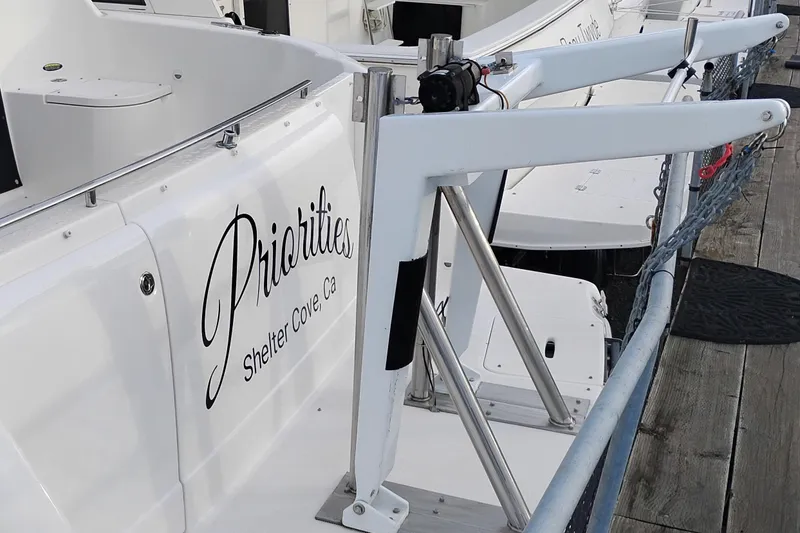 Slide: The Image of 2004 Meridian 459 Motoryacht docked, featuring "Priorities" name and davit system. - 3