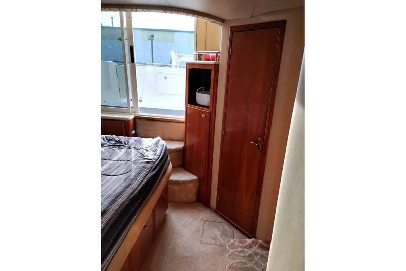 Slide: The Image of Interior of 2004 Meridian 459 Motoryacht with bed, window, and wooden door. - 34