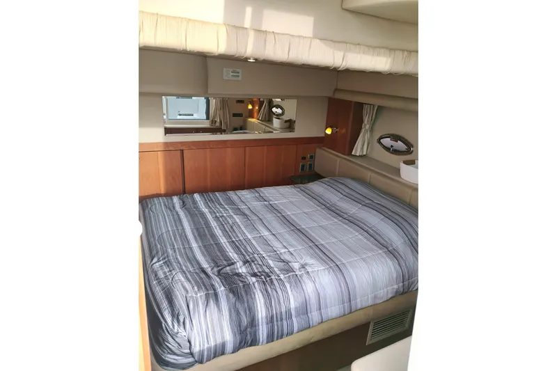 Slide: The Image of Luxurious bedroom interior of 2004 Meridian 459 Motoryacht with striped bedding. - 38