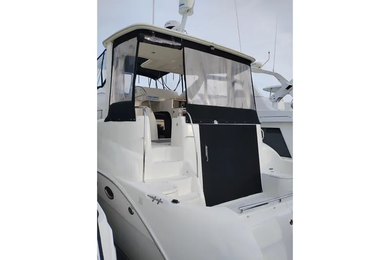 Slide: The Image of 2004 Meridian 459 Motoryacht with enclosed upper deck and sleek white exterior. - 4