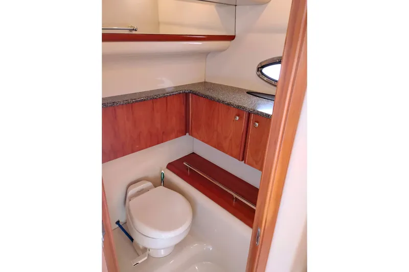 Slide: The Image of 2004 Meridian 459 Motoryacht bathroom with wooden cabinets and granite countertop. - 41