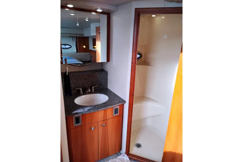 Slide: The Image of 2004 Meridian 459 Motoryacht bathroom with sink, mirror, and shower. - 44