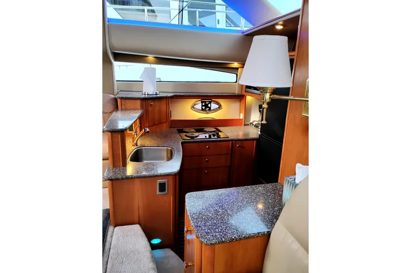 Slide: The Image of Luxurious 2004 Meridian 459 Motoryacht interior kitchen with modern amenities and elegant design. - 46
