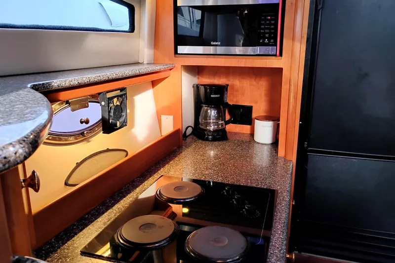 Slide: The Image of Kitchen area of 2004 Meridian 459 Motoryacht with stove, microwave, and coffee maker. - 49