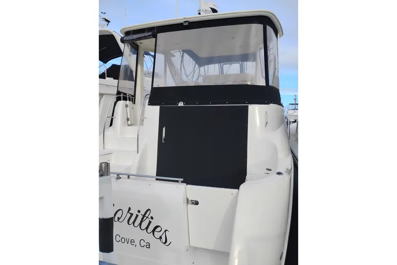 Slide: The Image of 2004 Meridian 459 Motoryacht docked, rear view with covered deck area. - 5