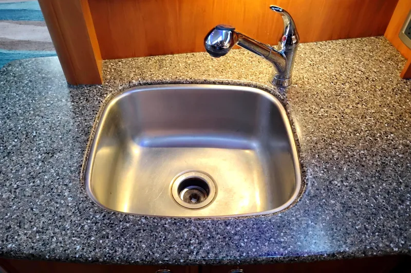 Slide: The Image of Stainless steel sink and faucet on granite countertop in 2004 Meridian 459 Motoryacht. - 51
