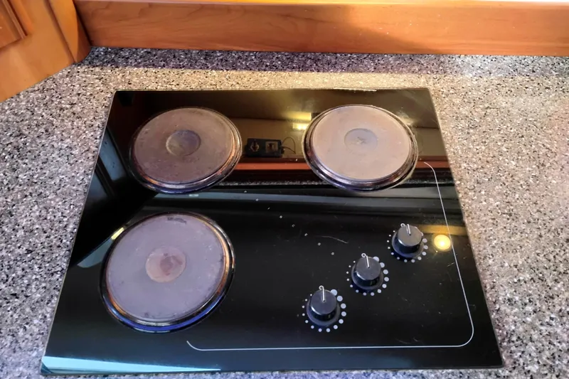Slide: The Image of Electric stovetop with three burners and control knobs on a Meridian 459 Motoryacht, 2004 model. - 52