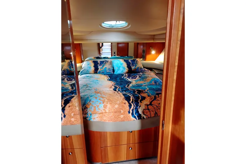 Slide: The Image of Luxurious bedroom in 2004 Meridian 459 Motoryacht with vibrant bedding and wood accents. - 55