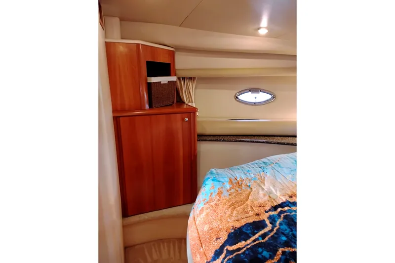 Slide: The Image of Luxurious 2004 Meridian 459 Motoryacht cabin interior with wood cabinetry and porthole window. - 57