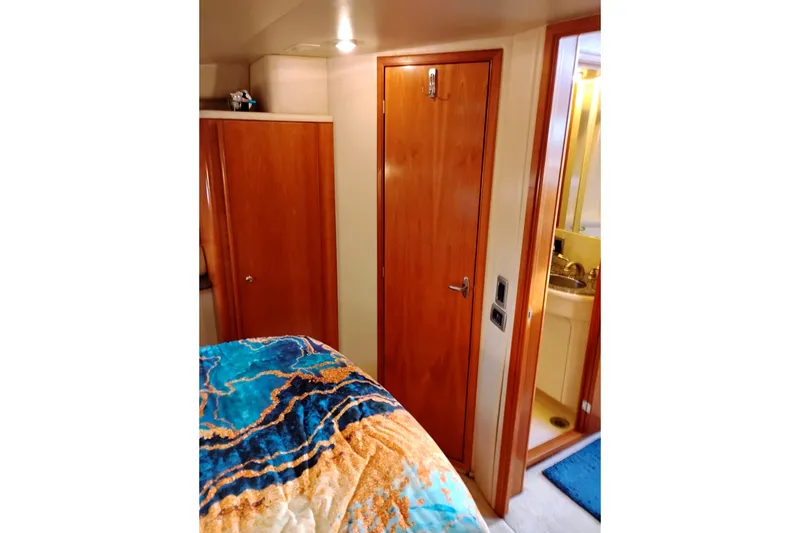 Slide: The Image of Interior of 2004 Meridian 459 Motoryacht with wooden doors and colorful bedding. - 58