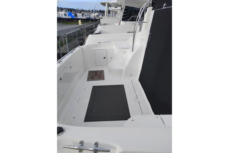 Slide: The Image of 2004 Meridian 459 Motoryacht deck with white finish and marina view. - 6