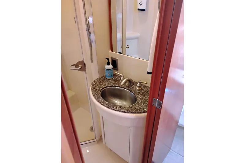 Slide: The Image of Bathroom sink area in 2004 Meridian 459 Motoryacht, featuring granite countertop and modern fixtures. - 62