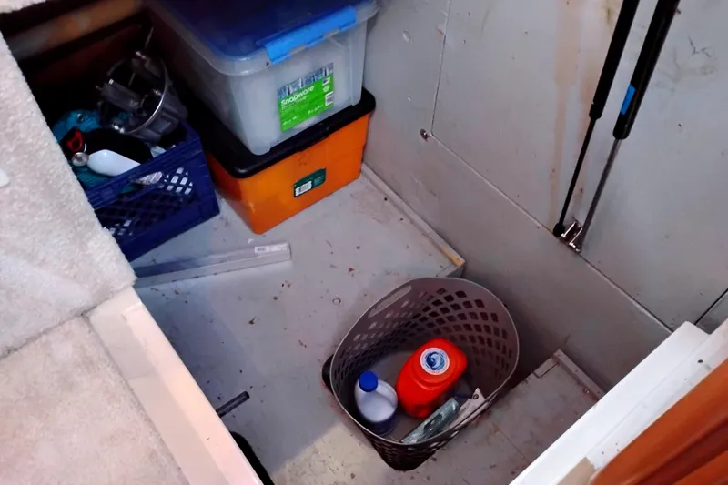 Slide: The Image of Storage area on a 2004 Meridian 459 Motoryacht with containers and cleaning supplies. - 64