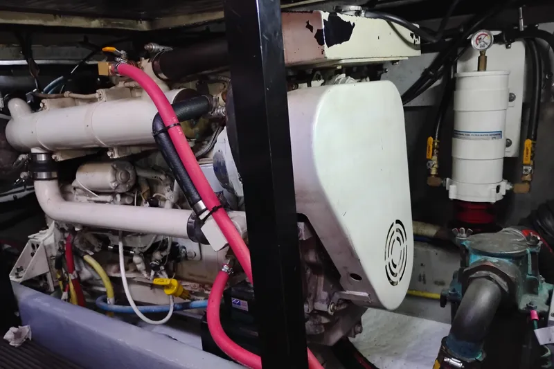 Slide: The Image of Engine room of a 2004 Meridian 459 Motoryacht with visible components and piping. - 69