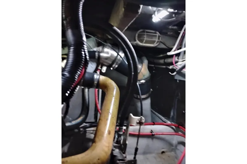 Slide: The Image of Engine room of 2004 Meridian 459 Motoryacht with visible hoses and wiring. - 77