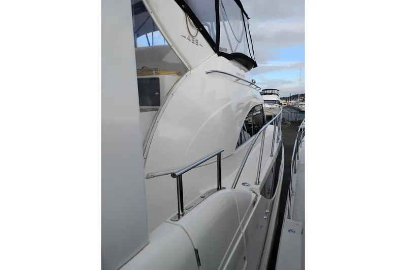Slide: The Image of 2004 Meridian 459 Motoryacht docked, showcasing sleek design and polished railings. - 80