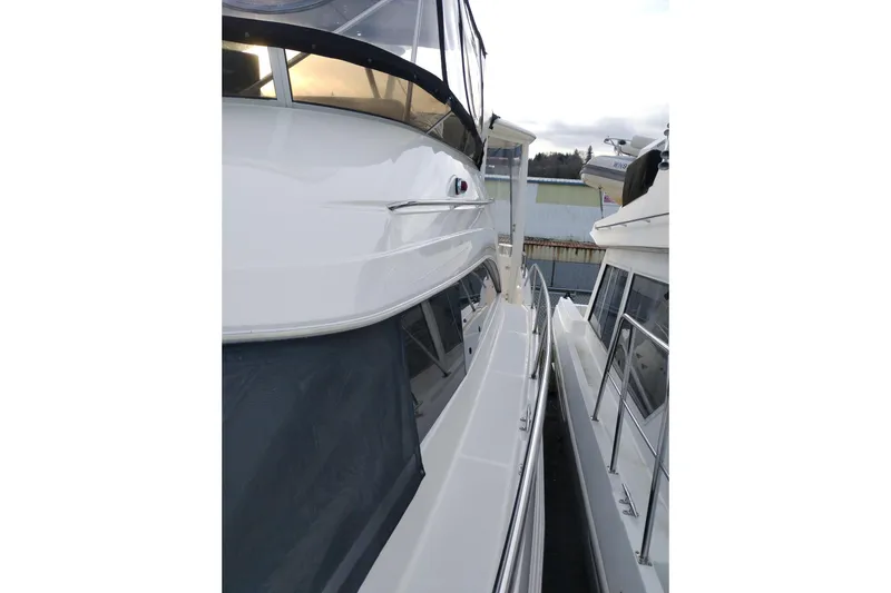 Slide: The Image of 2004 Meridian 459 Motoryacht side view, showcasing sleek design and docked position. - 82