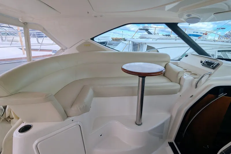 Slide: The Image of 2008 Tiara Yachts 3600 Sovran interior with cream seating and wooden table. - 11