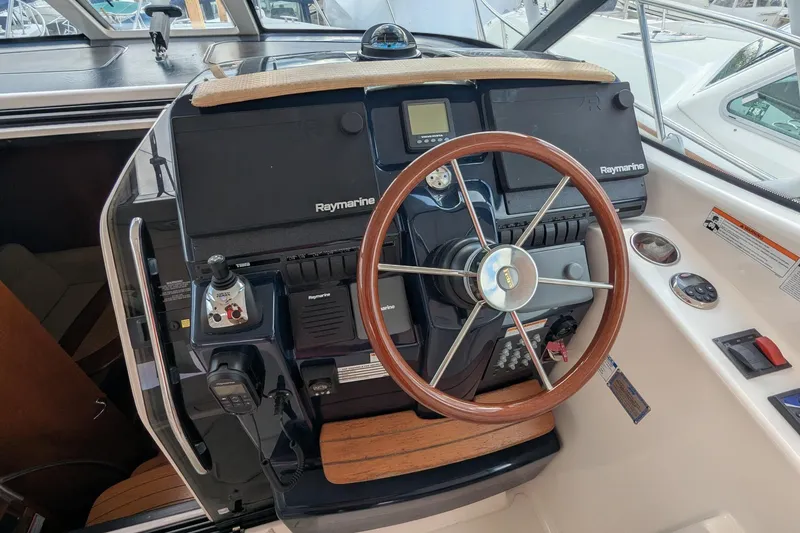 Slide: The Image of 2008 Tiara Yachts 3600 Sovran helm with Raymarine electronics and wooden steering wheel. - 15