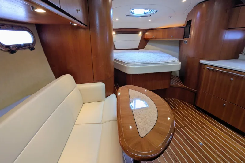 Slide: The Image of 2008 Tiara Yachts 3600 Sovran interior with wood finish, seating, and bed. - 22