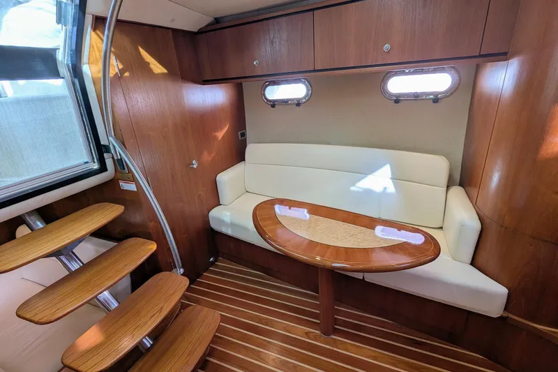Slide: The Image of 2008 Tiara Yachts 3600 Sovran interior with wooden flooring and elegant seating area. - 24