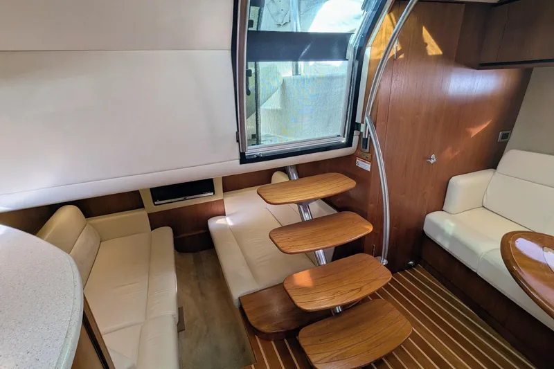 Slide: The Image of Interior of 2008 Tiara Yachts 3600 Sovran with elegant seating and wooden steps. - 25