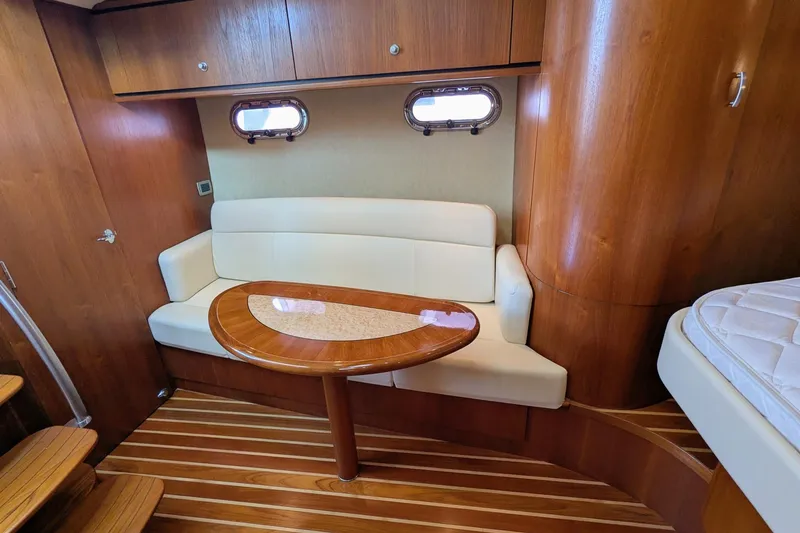 Slide: The Image of Interior of 2008 Tiara Yachts 3600 Sovran with wooden finish and cozy seating area. - 28