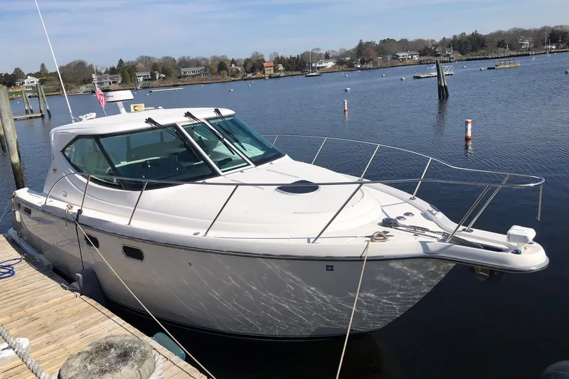 Slide: The Image of 2008 Tiara Yachts 3600 Sovran docked in a serene marina setting. - 3