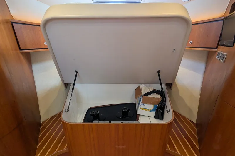 Slide: The Image of 2008 Tiara Yachts 3600 Sovran interior with open storage compartment and wooden cabinetry. - 31