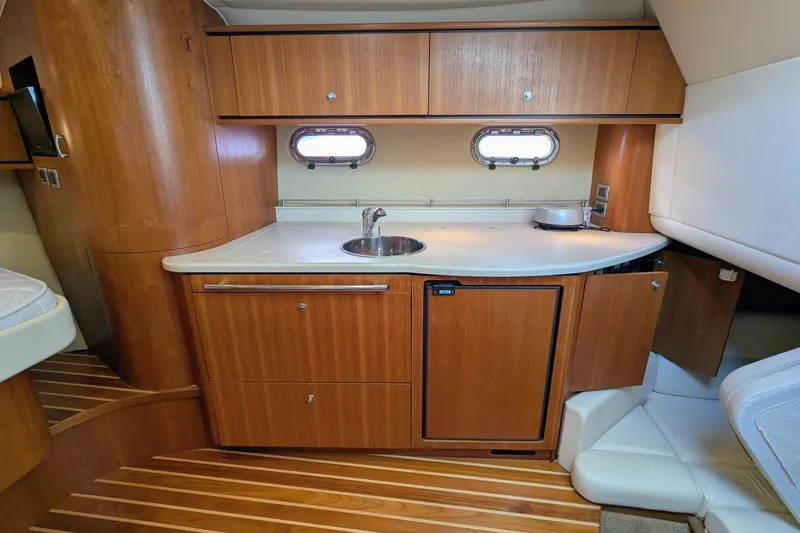 Slide: The Image of 2008 Tiara Yachts 3600 Sovran interior kitchen with wood cabinetry and compact design. - 33