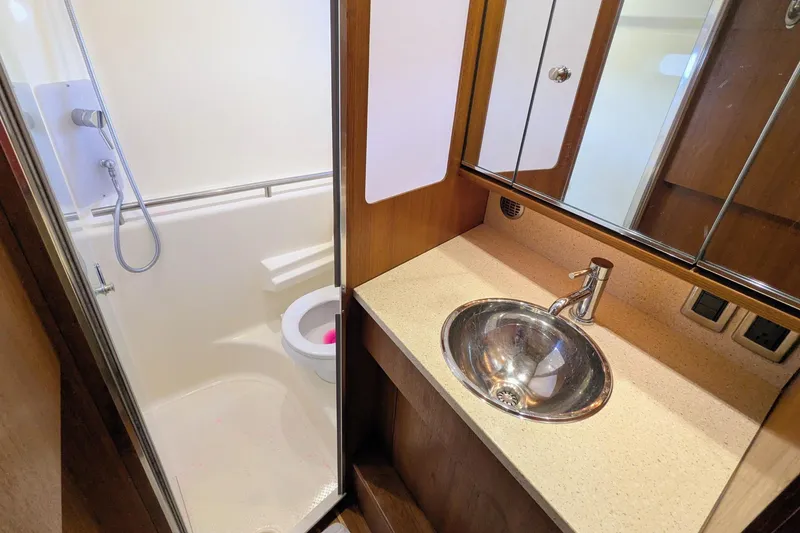 Slide: The Image of 2008 Tiara Yachts 3600 Sovran bathroom with shower, sink, and mirror. - 40