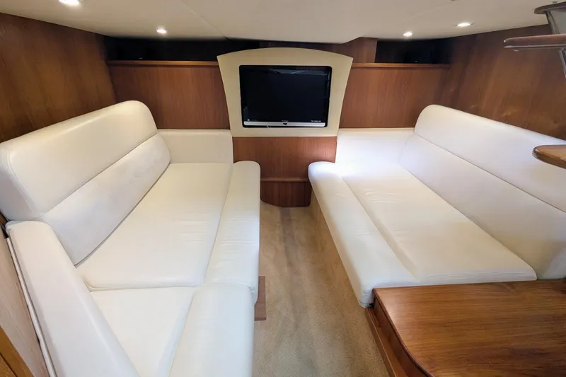 Slide: The Image of Interior of 2008 Tiara Yachts 3600 Sovran with white leather seating and wood accents. - 44