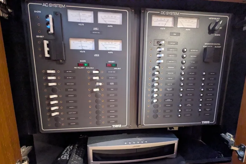 Slide: The Image of Electrical control panel of a 2008 Tiara Yachts 3600 Sovran, featuring AC and DC systems. - 46