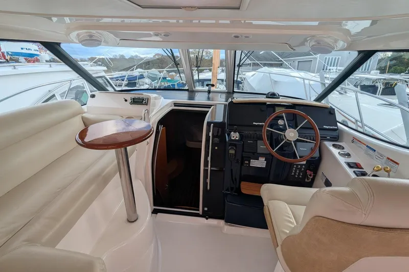Slide: The Image of 2008 Tiara Yachts 3600 Sovran helm with leather seating and wooden steering wheel. - 8