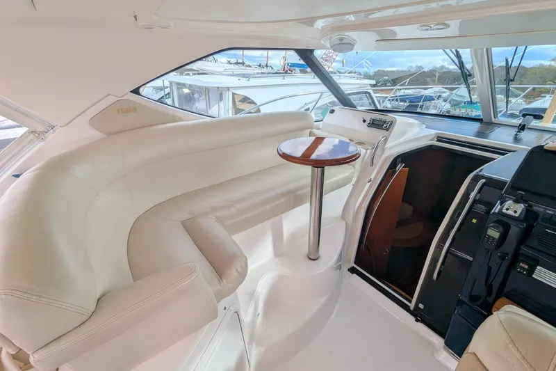 Slide: The Image of 2008 Tiara Yachts 3600 Sovran interior with white seating and wooden table. - 9