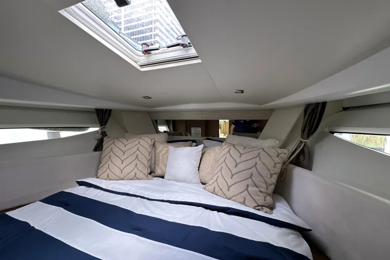 Slide: The Image of Luxurious cabin interior of 2017 Jeanneau NC 11 with skylight and plush bedding. - 73