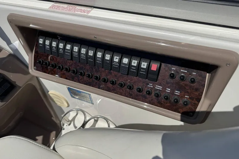 Slide: The Image of Control panel of a 2004 Regal 3060 Window Express boat with various switches. - 11
