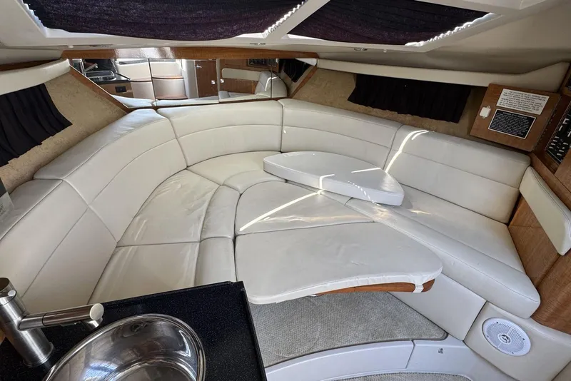 Slide: The Image of 2004 Regal 3060 Window Express interior with white leather seating and modern amenities. - 12