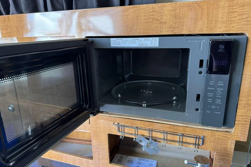 Slide: The Image of Open microwave in 2004 Regal 3060 Window Express boat interior. - 17