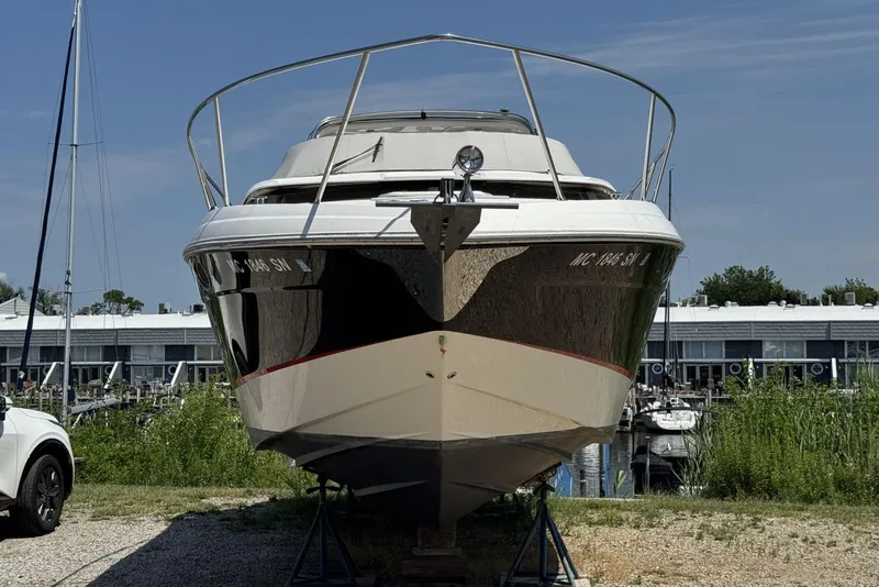 Slide: The Image of 2004 Regal 3060 Window Express boat on land near marina, sunny day. - 2