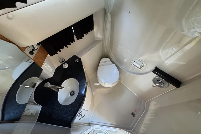 Slide: The Image of 2004 Regal 3060 Window Express bathroom with sink, toilet, and shower area. - 20