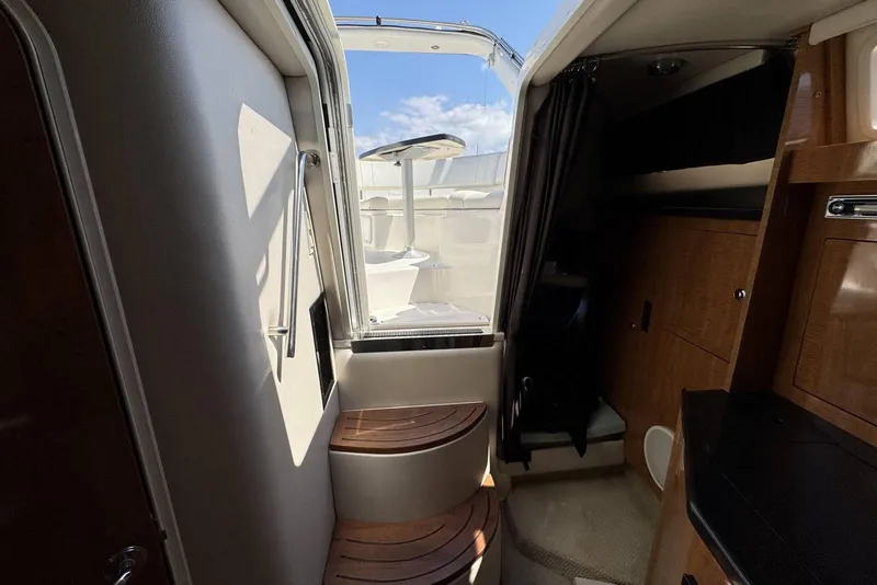 Slide: The Image of Interior view of 2004 Regal 3060 Window Express boat, featuring wooden steps and cabinetry. - 21