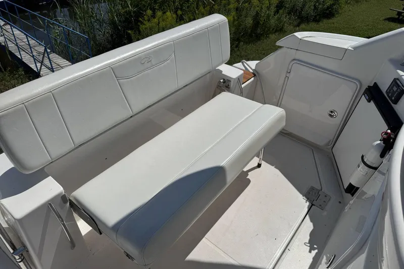 Slide: The Image of 2004 Regal 3060 Window Express boat interior with white seating and storage compartment. - 6