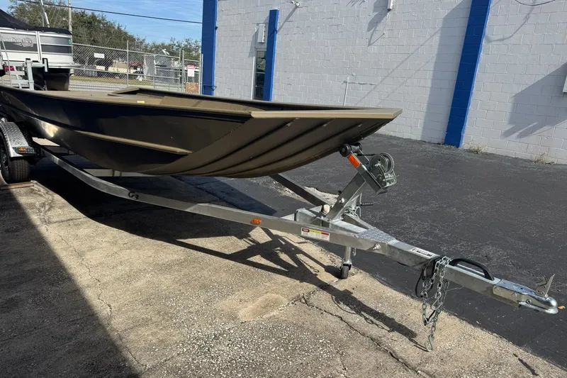 Slide: The Image of 2026 G3 Gator Tough 1860 VBW boat on trailer, parked outdoors. - 4